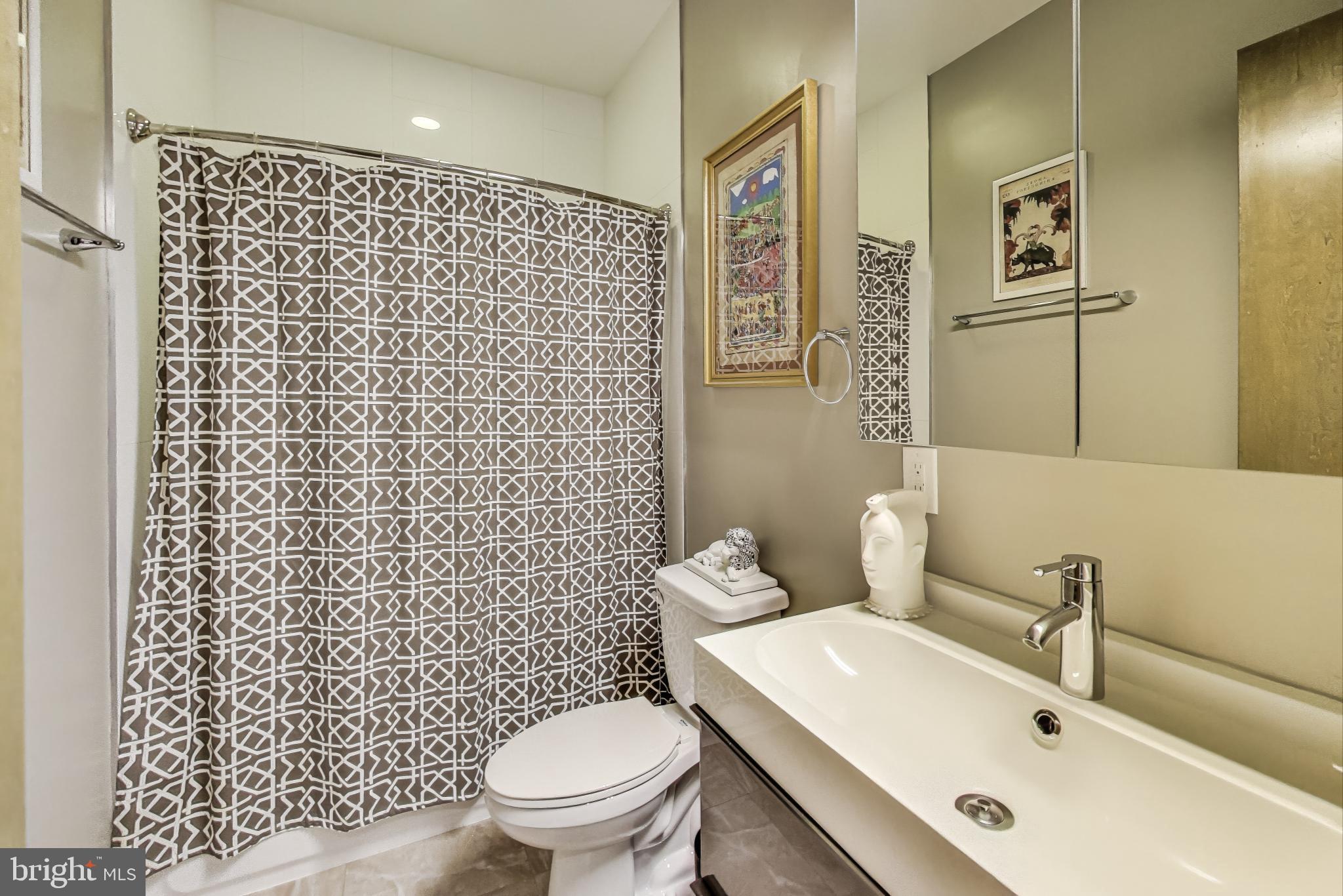 1242 New Jersey Avenue Northwest Washington, DC 20001 - Photo 18 of 60 a bathroom with a sink a toilet and a shower