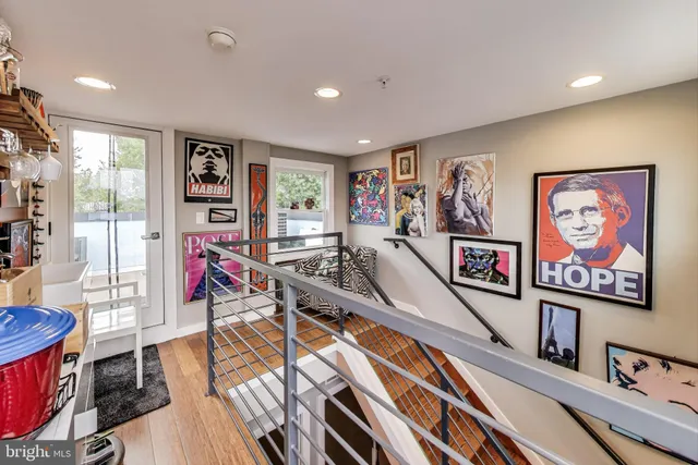 a bathroom with a sink mirror and clock on th wall