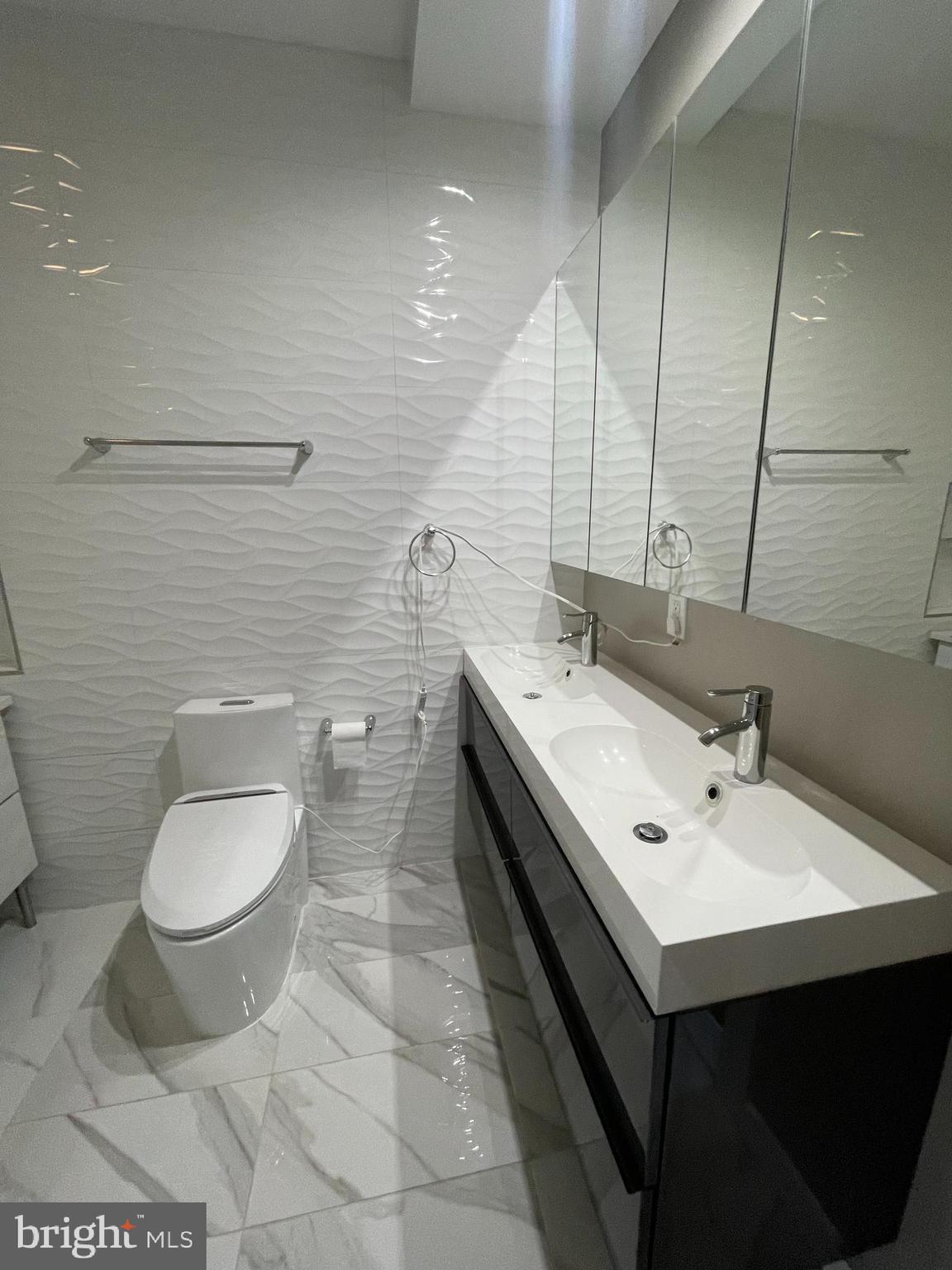 1242 New Jersey Avenue Northwest Washington, DC 20001 - Photo 45 of 60 a bathroom with a sink toilet and mirror