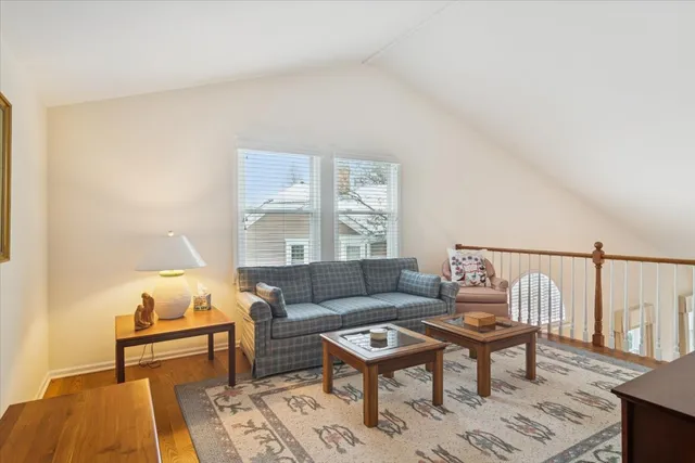 a living room with furniture a rug and a window