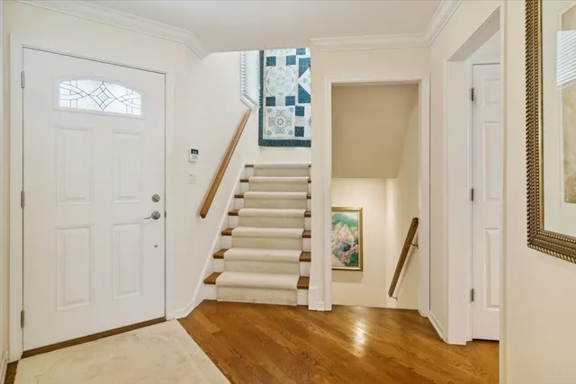 a view of a hallway with wooden floor and entryway