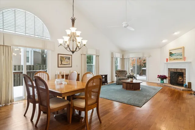 a view of a dining room with furniture a chandelier and wooden floor