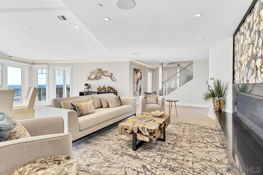 274 Coast Boulevard La Jolla, CA 92037 - Photo 12 of 64 a living room with furniture and a fireplace