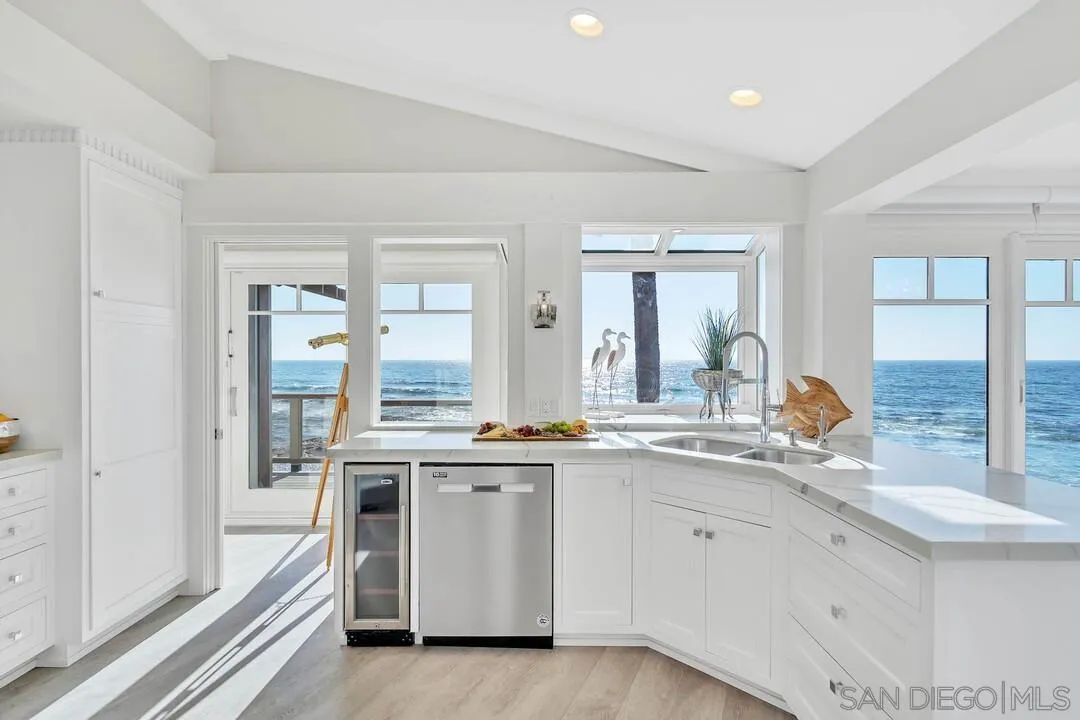 274 Coast Boulevard La Jolla, CA 92037 - Photo 18 of 64 a kitchen with a sink stove and cabinets