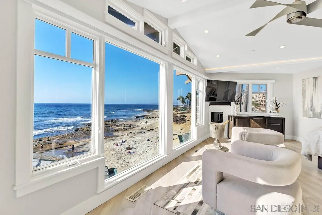 274 Coast Boulevard La Jolla, CA 92037 - Photo 23 of 64 a living room with furniture a rug and kitchen view