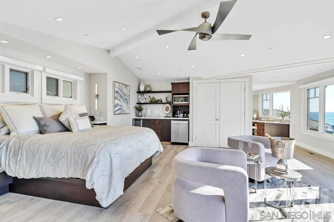 274 Coast Boulevard La Jolla, CA 92037 - Photo 24 of 64 a spacious bedroom with a large bed and a wooden floor