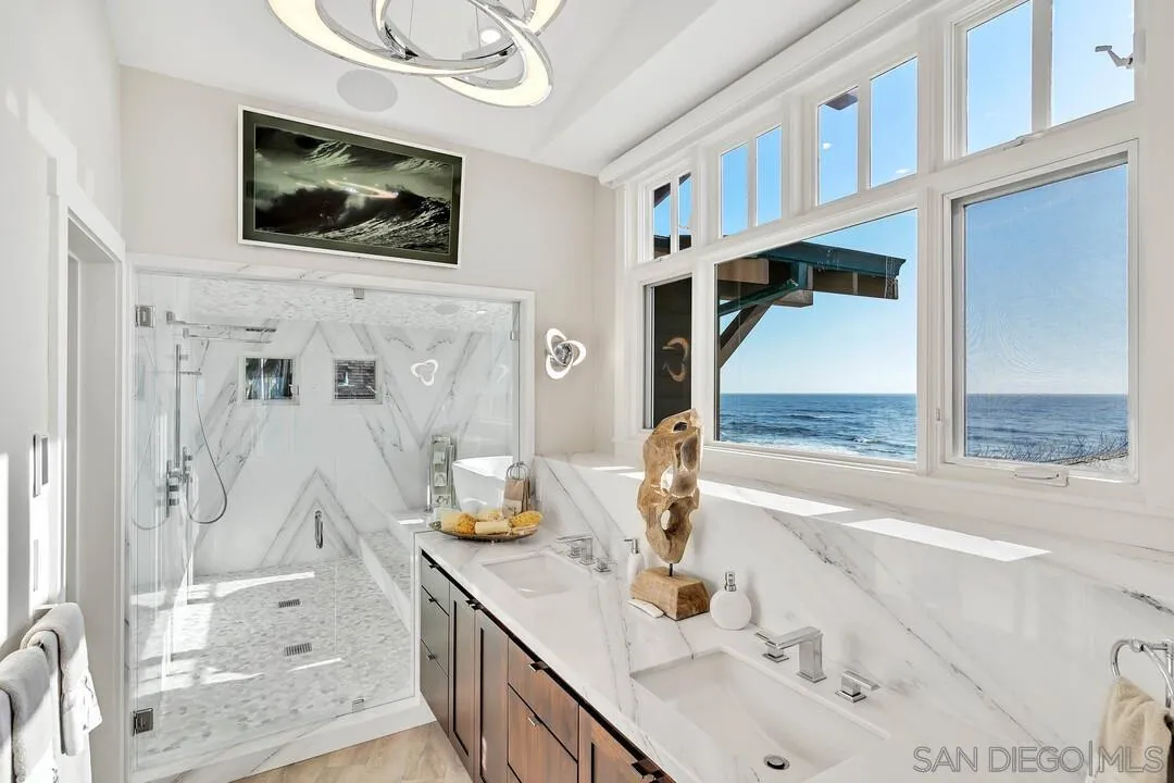 274 Coast Boulevard La Jolla, CA 92037 - Photo 26 of 64 a bathroom with a tub sink and mirror