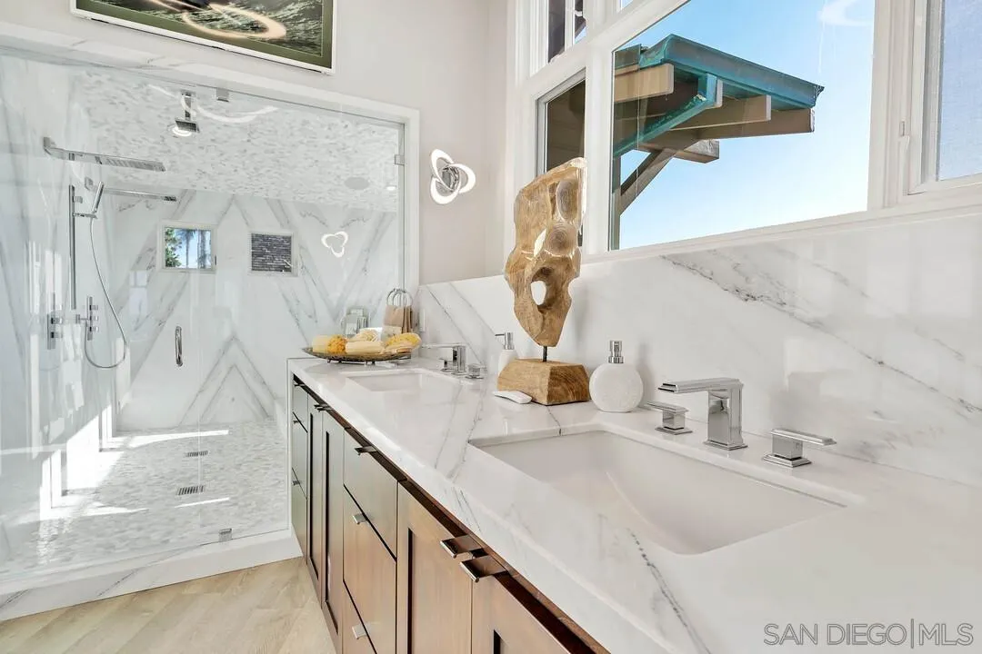 274 Coast Boulevard La Jolla, CA 92037 - Photo 27 of 64 a bathroom with a sink and a mirror