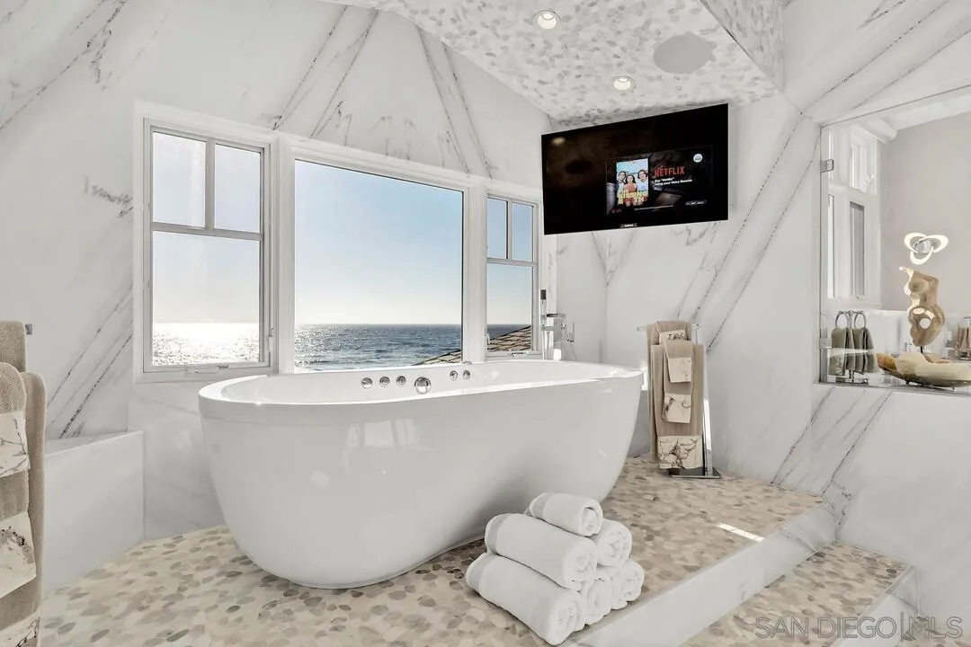 274 Coast Boulevard La Jolla, CA 92037 - Photo 30 of 64 a living room with a flat screen tv and a fireplace