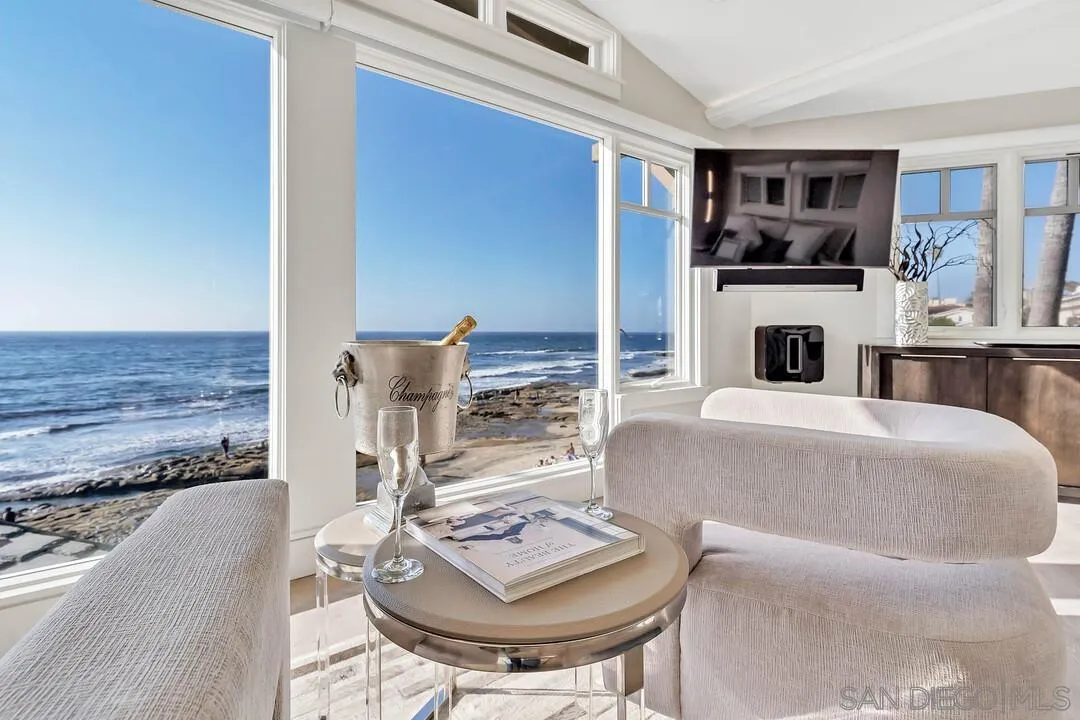 274 Coast Boulevard La Jolla, CA 92037 - Photo 32 of 64 a living room with furniture and a fireplace