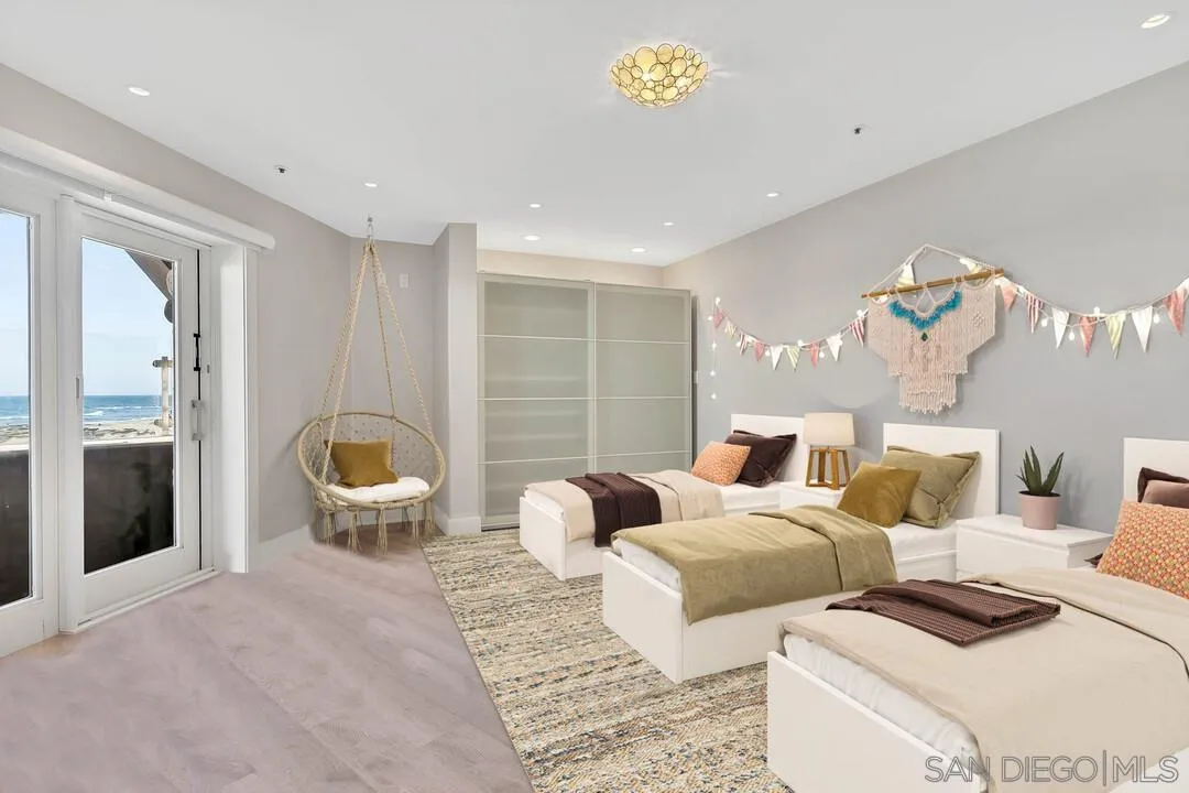 274 Coast Boulevard La Jolla, CA 92037 - Photo 39 of 64 a bedroom with furniture and a large window