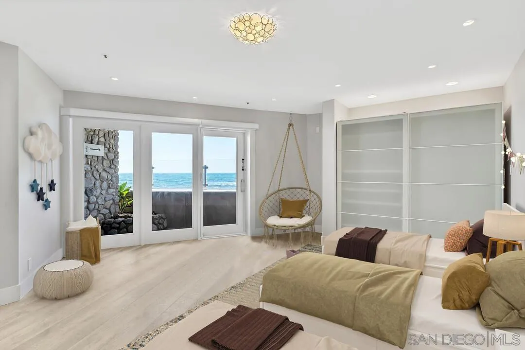 274 Coast Boulevard La Jolla, CA 92037 - Photo 40 of 64 a bedroom with furniture and large windows