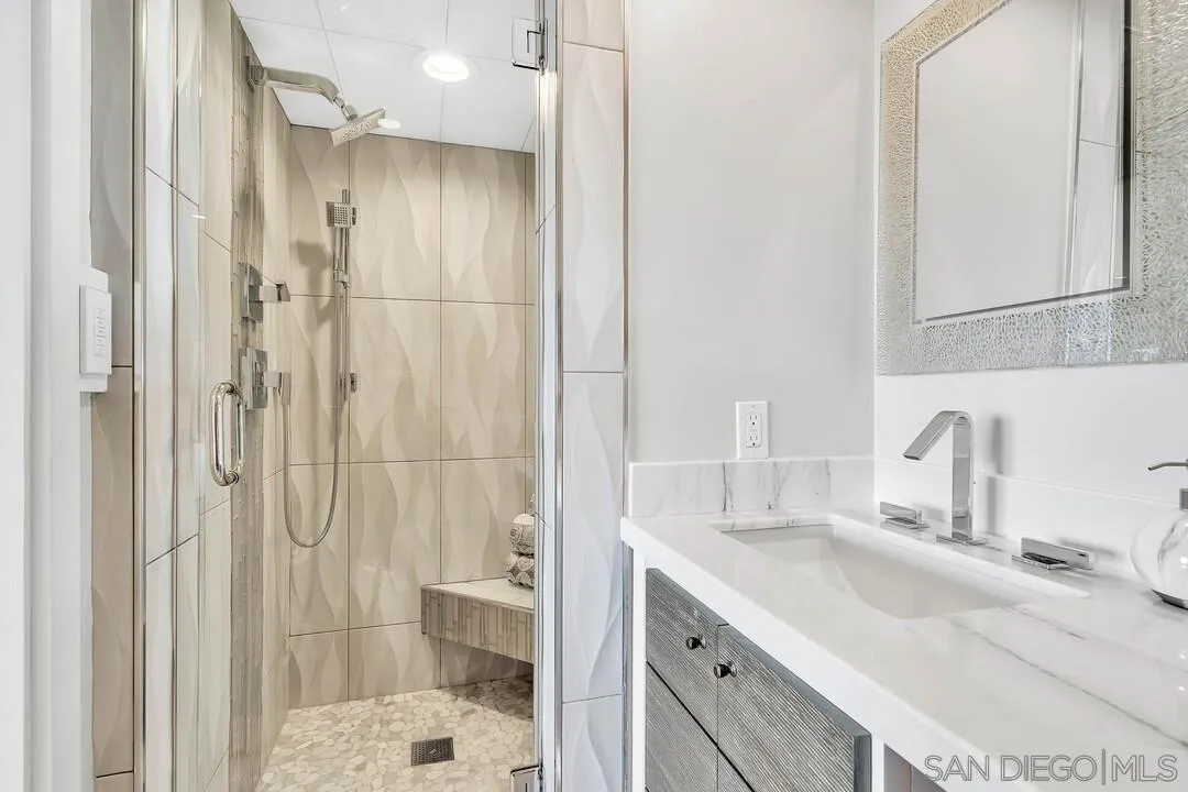 274 Coast Boulevard La Jolla, CA 92037 - Photo 43 of 64 a bathroom with a sink and a mirror