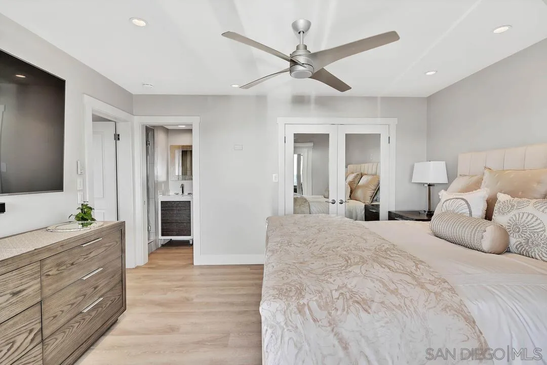 274 Coast Boulevard La Jolla, CA 92037 - Photo 44 of 64 a bedroom with a large bed and a dresser