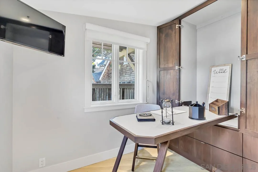 274 Coast Boulevard La Jolla, CA 92037 - Photo 49 of 64 a bathroom with a sink a mirror and a window