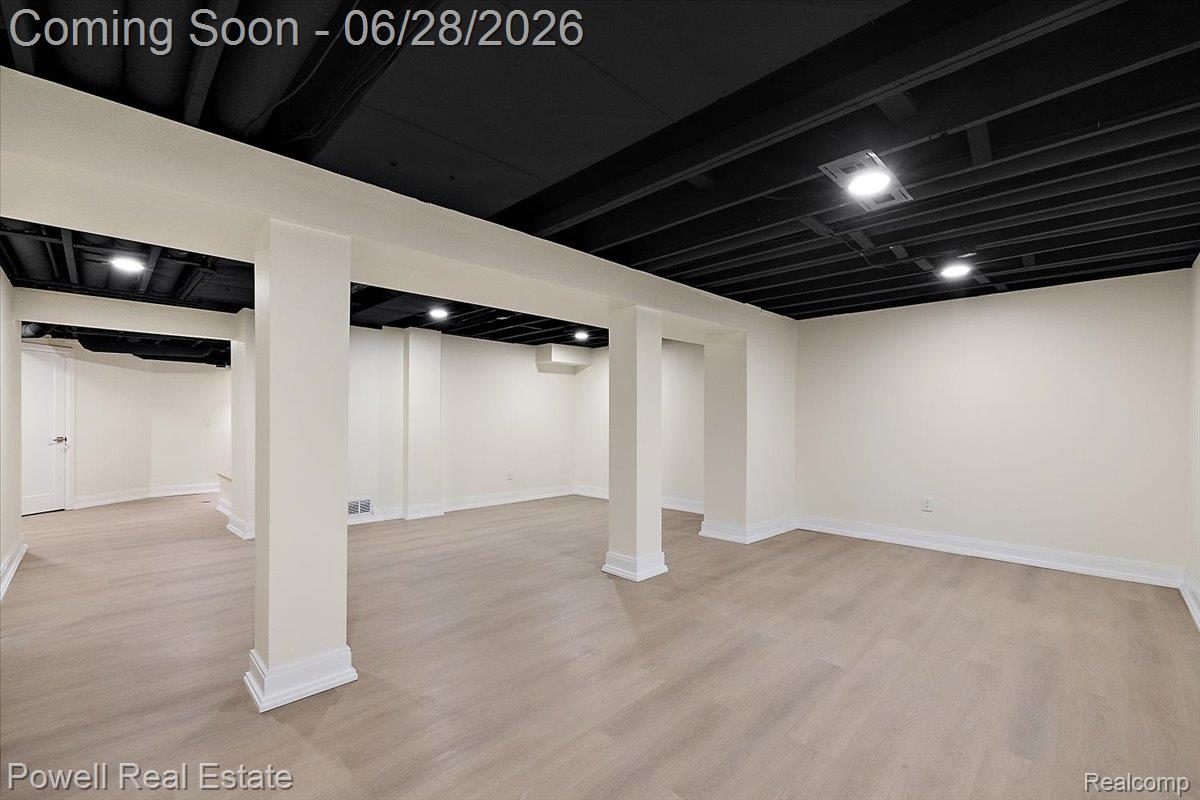 1447 Ravineview Court, Unit C12 Bloomfield Hills, MI 48304 - Photo 49 of 49 Expansive lower level featuring light wood-finish flooring and a painted open-joist ceiling with recessed lighting