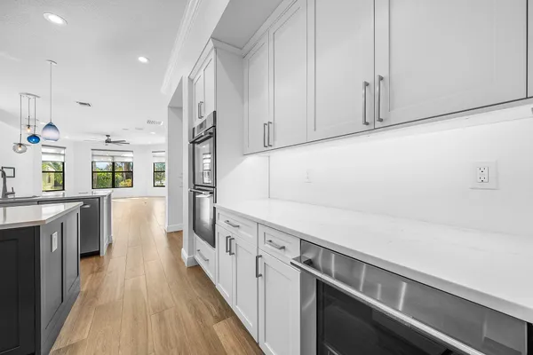 a kitchen with a sink stove and cabinets