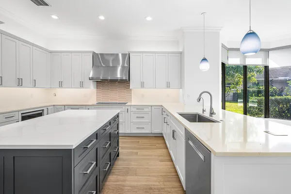 a kitchen with a stove a sink a microwave and wooden cabinets