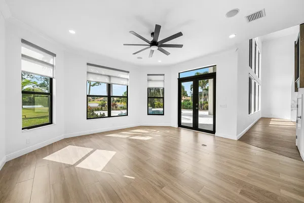 a view of a livingroom with a hardwood floor and a ceiling fan