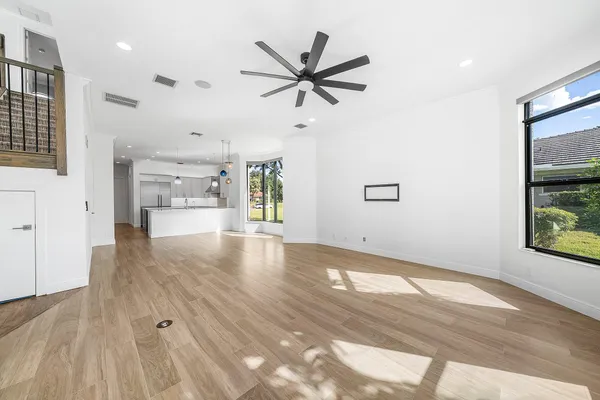 a utility room with stainless steel appliances granite countertop a sink a stove and cabinets