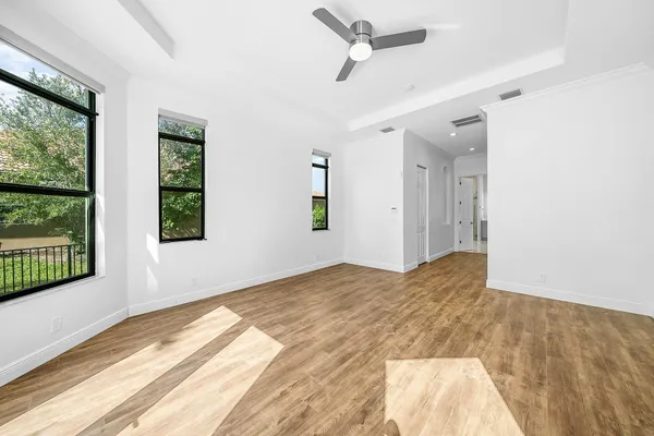 a large bathroom with a large tub sink vanity and granite