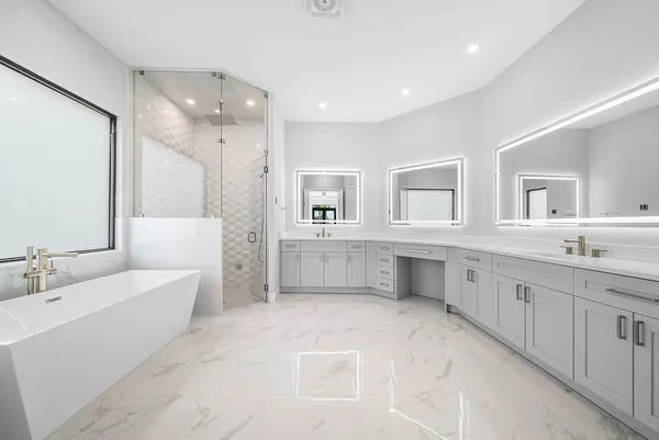 a spacious bathroom with stainless steel appliances granite countertop a sink and a mirror