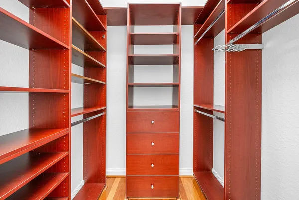 a view of walk in closet with empty racks