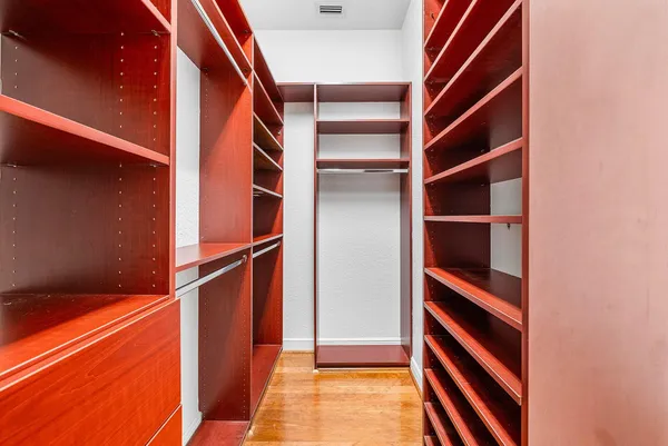 a view of a hallway with wooden floor and stairs