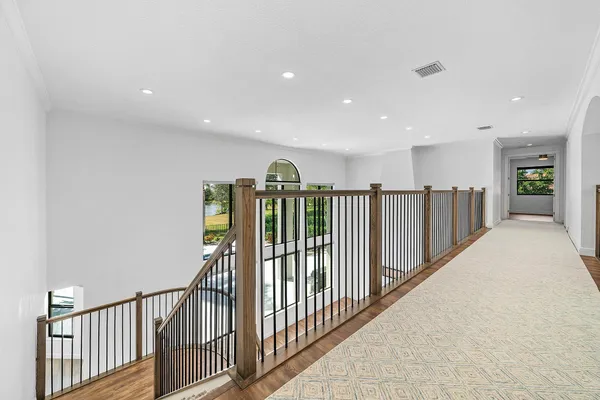 a view of a room with large windows and wooden floor