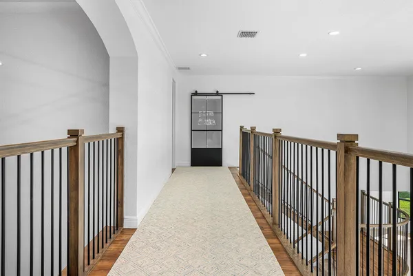 a view of empty room with wooden floor and window