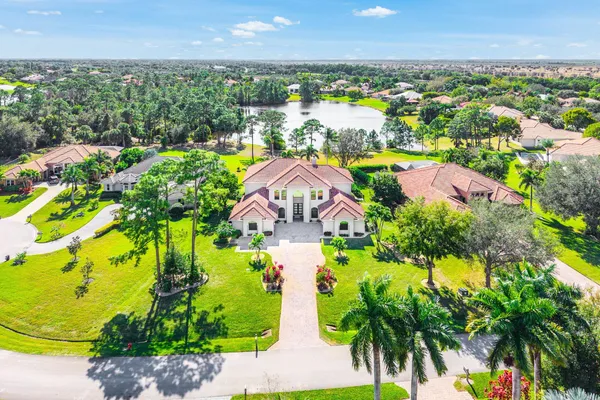 an aerial view of a house with a swimming pool outdoor seating and yard