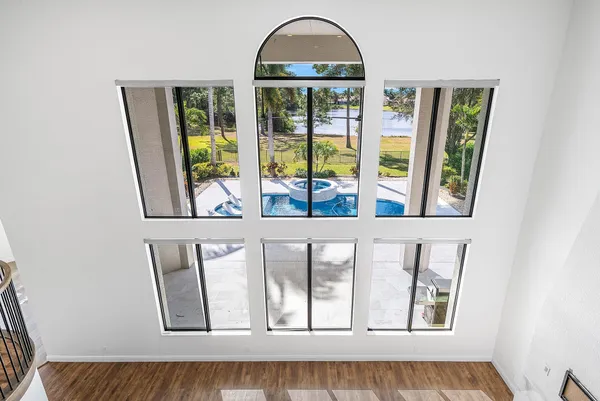 an empty room with windows and closet