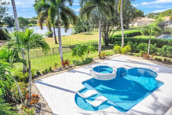 a view of a lake with couches in front of house