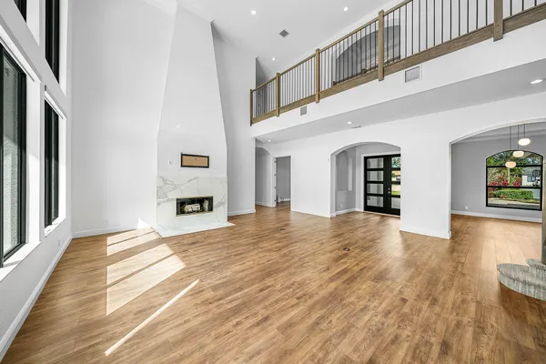 a view of a hallway with a window and stairs