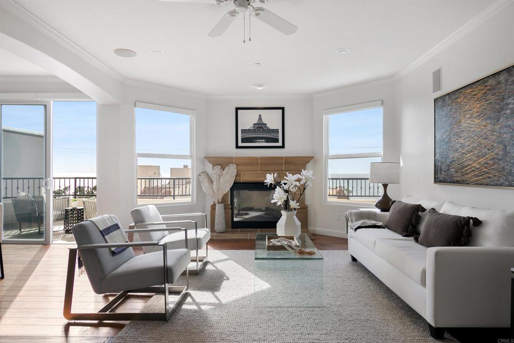 a living room with furniture a fireplace and a window