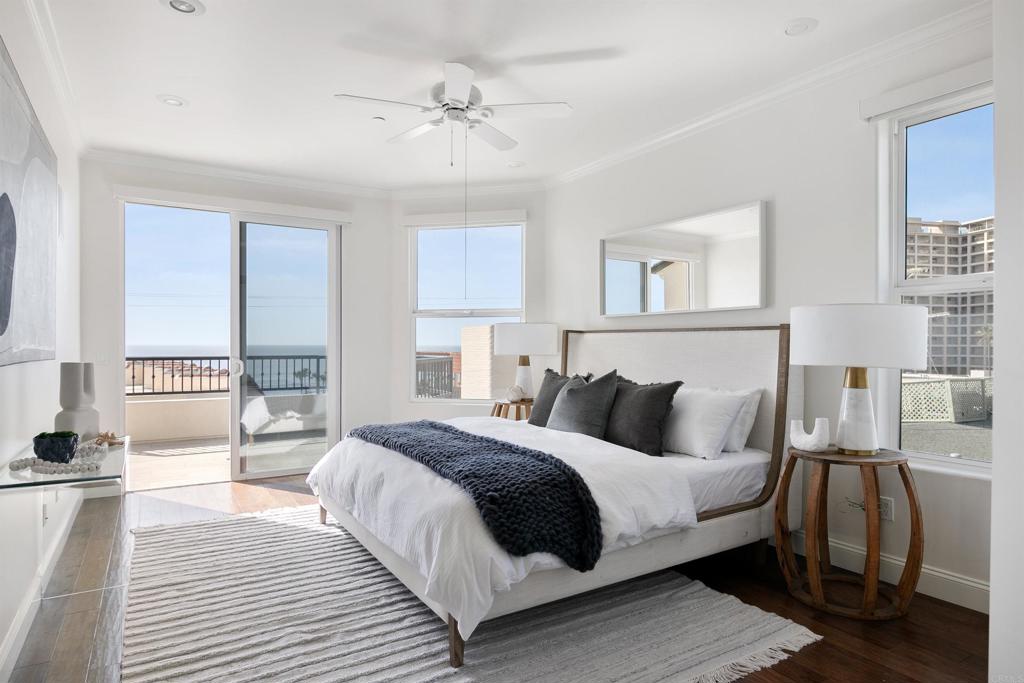 848 Prospect Street, Unit D La Jolla, CA 92037 - Photo 2 of 17 a bedroom with a large bed and a night stand