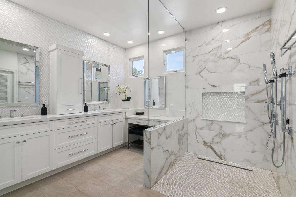 848 Prospect Street, Unit D La Jolla, CA 92037 - Photo 4 of 17 a spacious bathroom with a double vanity sink toilet mirror and bathtub