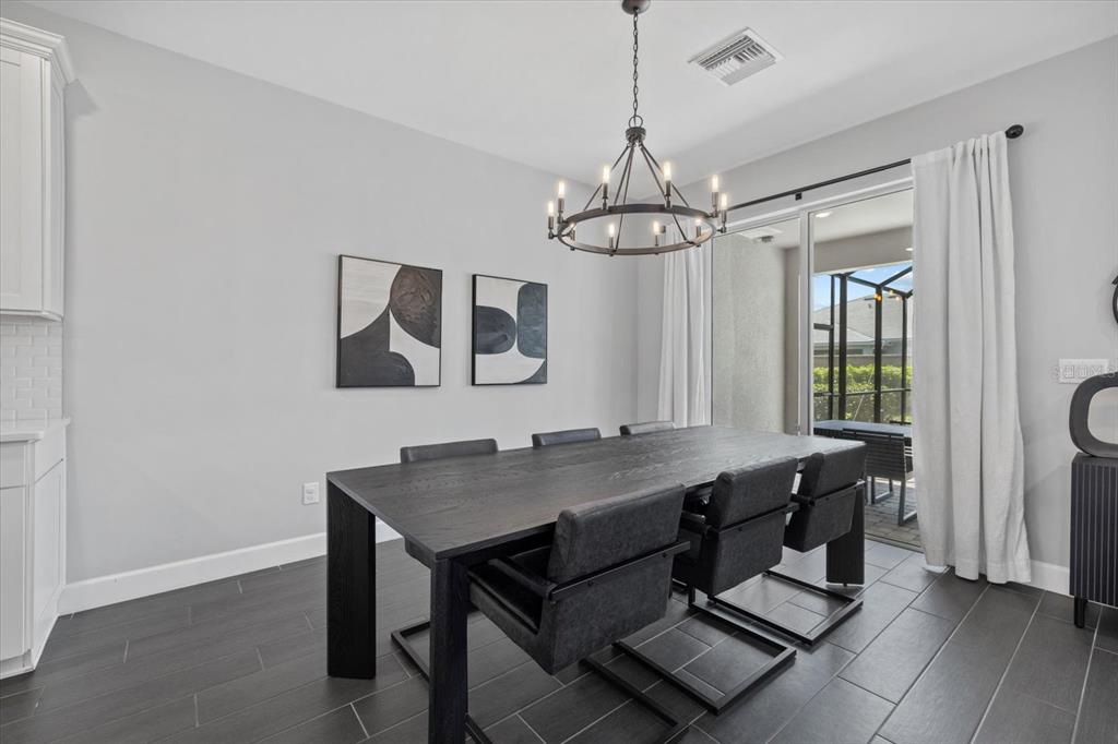 3508 Anchor Bay Trail Lakewood Ranch, FL 34211 - Photo 17 of 74 a dining room with a table and chairs