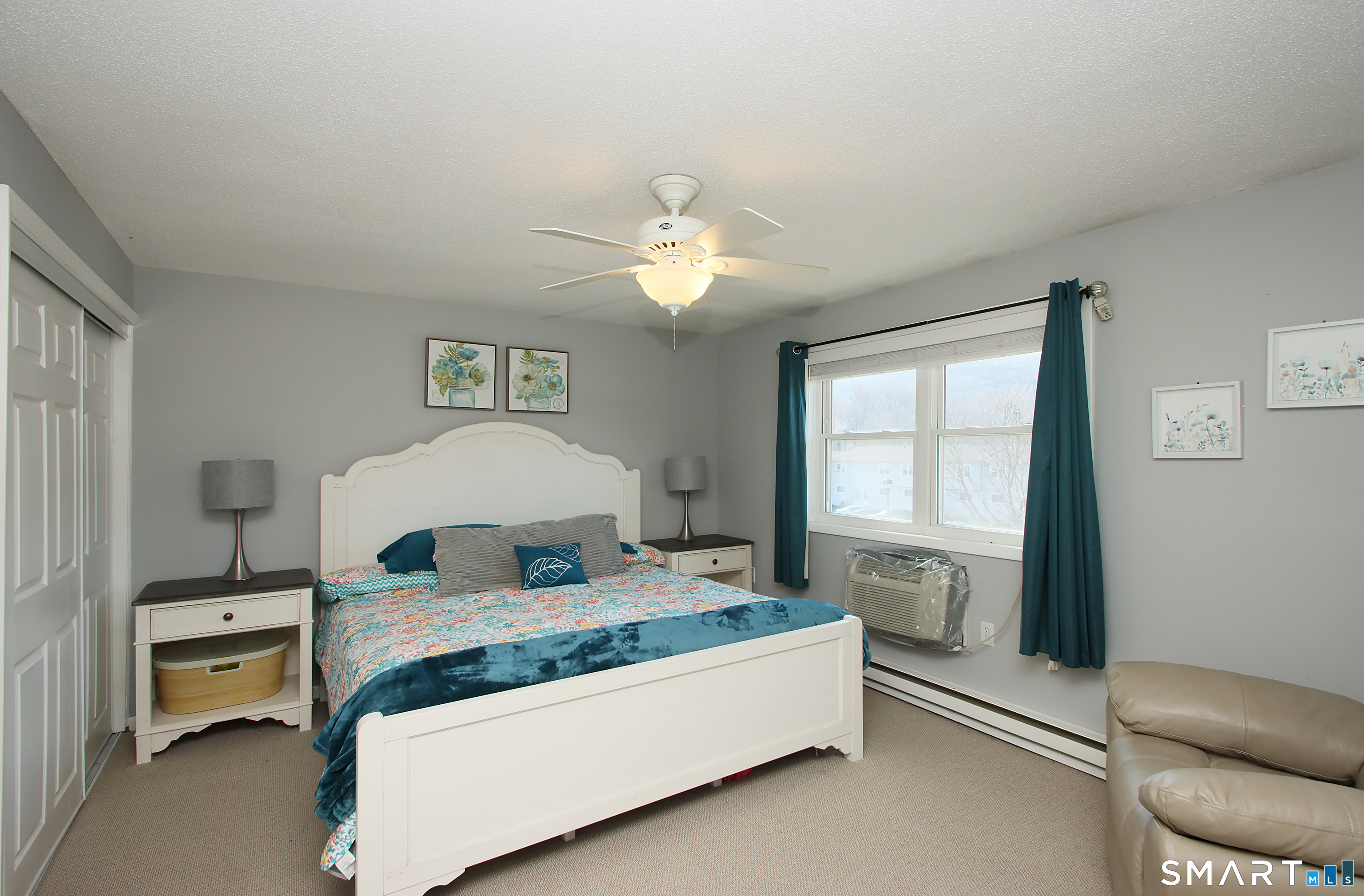 1081 New Haven Road, Unit 10C Naugatuck, CT 06770 - Photo 7 of 16 a bedroom with a bed and a chandelier