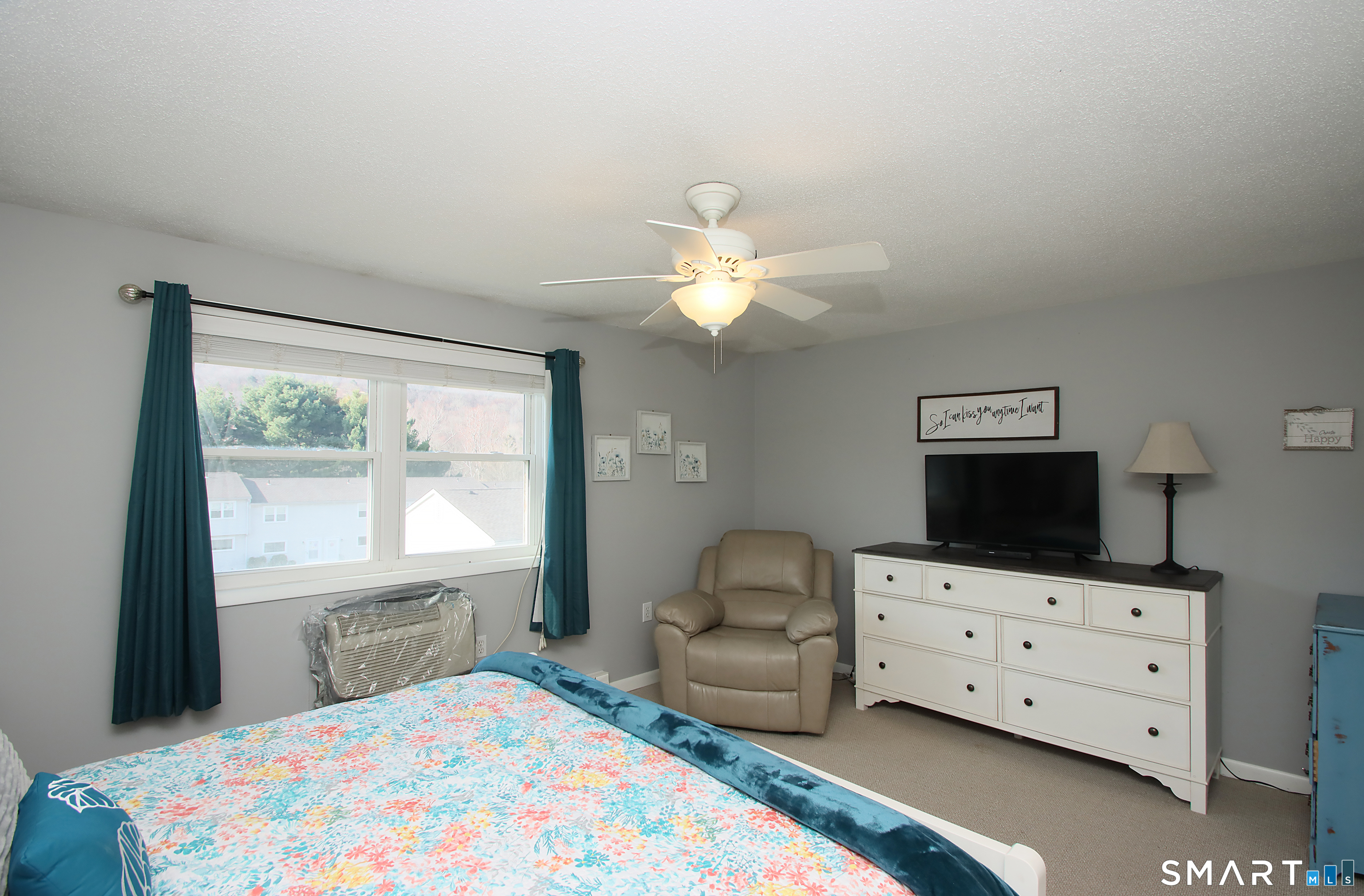1081 New Haven Road, Unit 10C Naugatuck, CT 06770 - Photo 8 of 16 a bedroom with a bed and a flat tv screen on the dresser