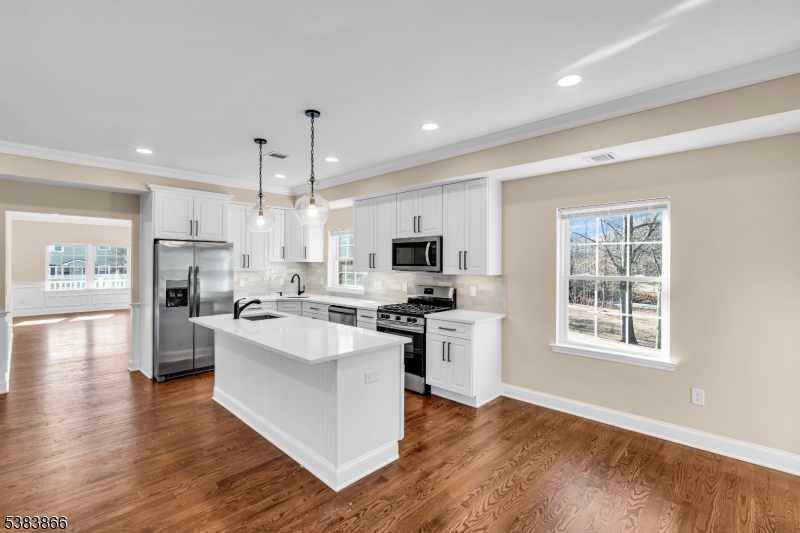 2000 Whittier Street Rahway, NJ 07065 - Photo 12 of 32 a kitchen with stainless steel appliances granite countertop a refrigerator a stove top oven a sink dishwasher and white cabinets with wooden floor