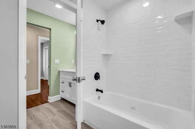 a bathroom with a bathtub with shower