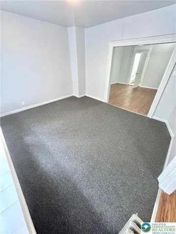 a view of an empty room and wooden floor