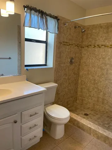 a bathroom with a toilet a sink and a shower