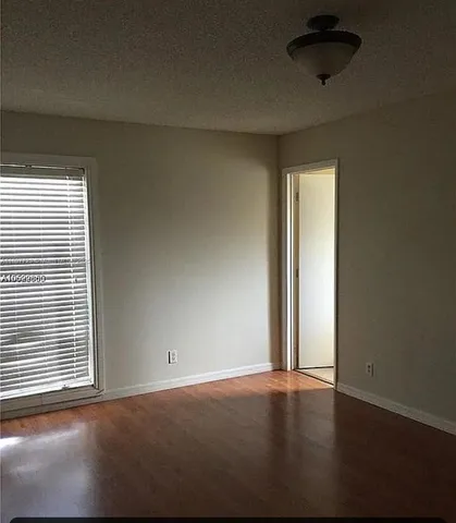 an empty room with a empty space and a window