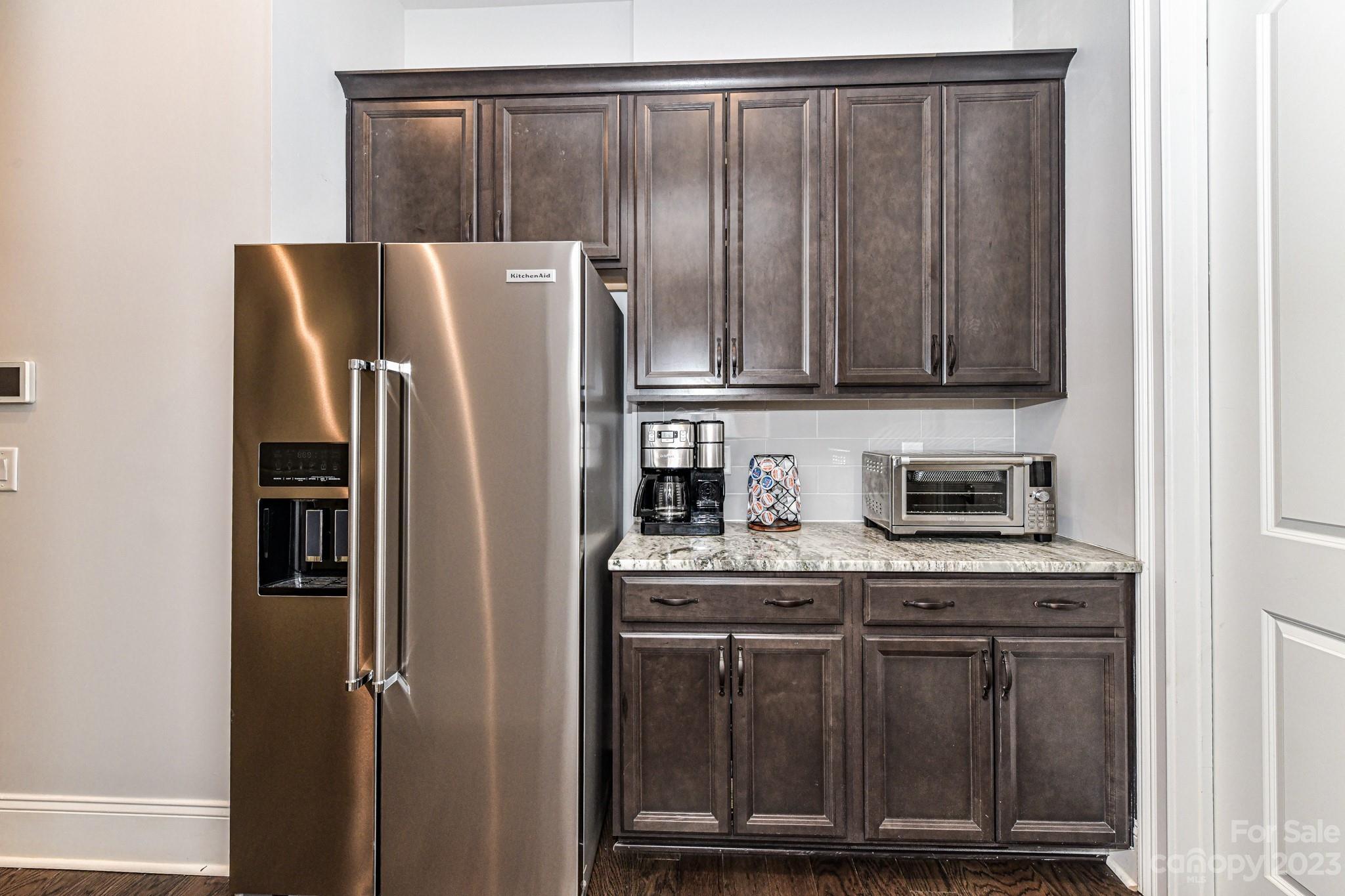 125 Turtleback Ridge, Unit 122 Matthews, NC 28104 - Photo 13 of 40 a metallic refrigerator freezer sitting in a kitchen