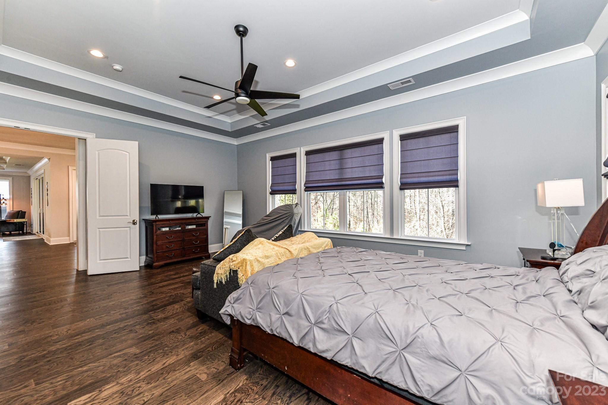 125 Turtleback Ridge, Unit 122 Matthews, NC 28104 - Photo 16 of 40 a bedroom with a bed ceiling fan and a window