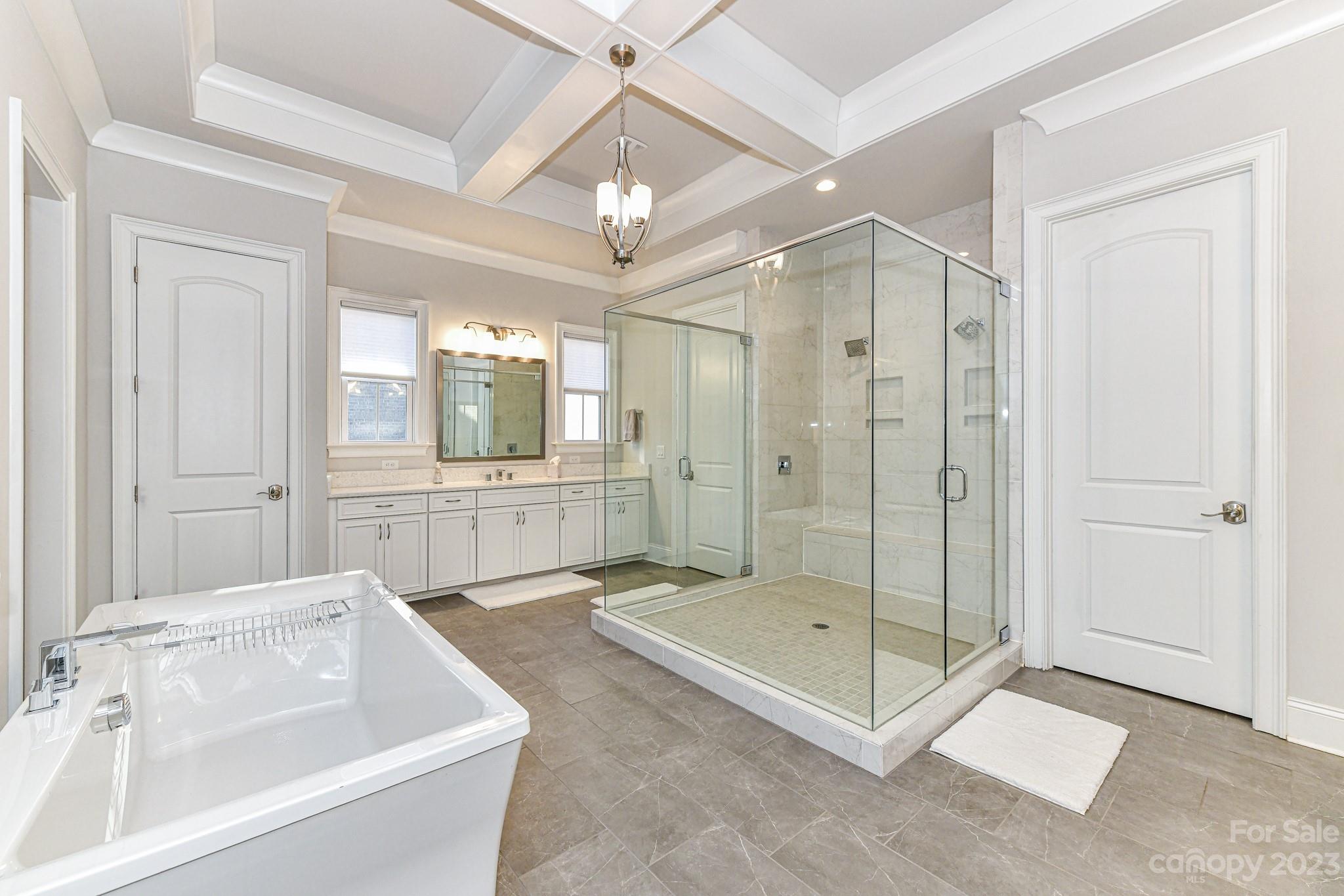 125 Turtleback Ridge, Unit 122 Matthews, NC 28104 - Photo 19 of 40 a bathroom with a tub shower and sink