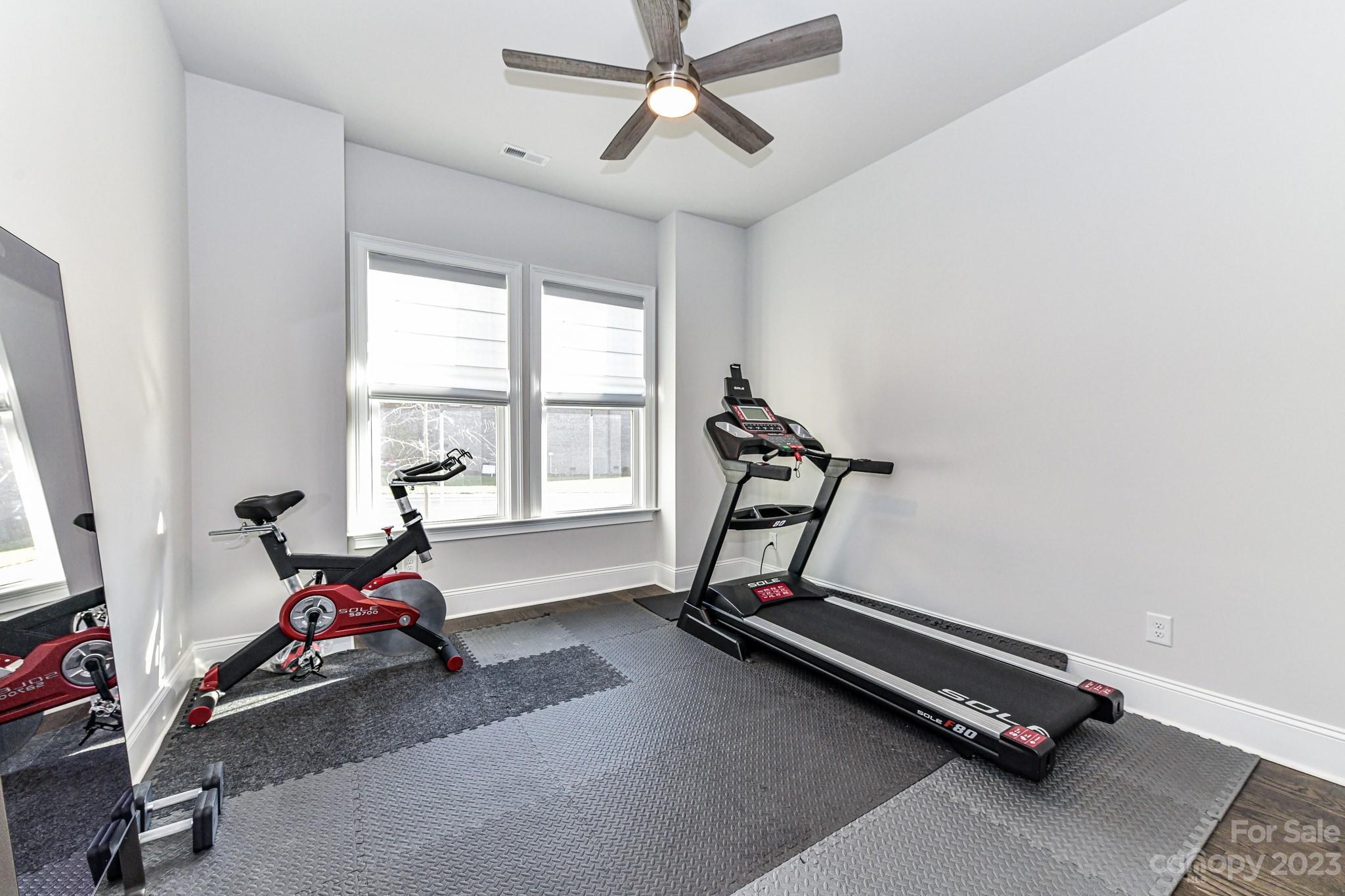 125 Turtleback Ridge, Unit 122 Matthews, NC 28104 - Photo 21 of 40 a room with gym equipment and windows