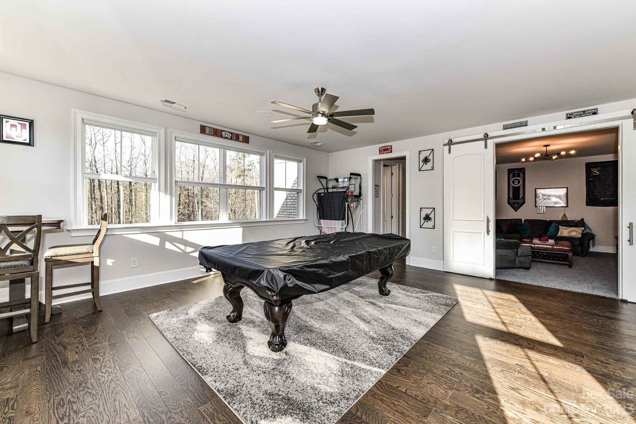 125 Turtleback Ridge, Unit 122 Matthews, NC 28104 - Photo 28 of 40 a living room with furniture pool table and a rug